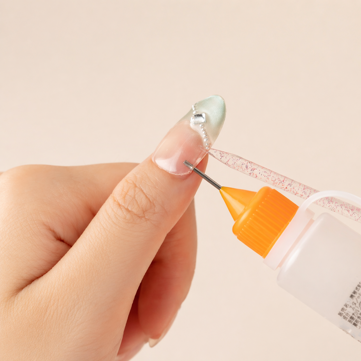 Applying portable nail adhesive gel to a nail tip