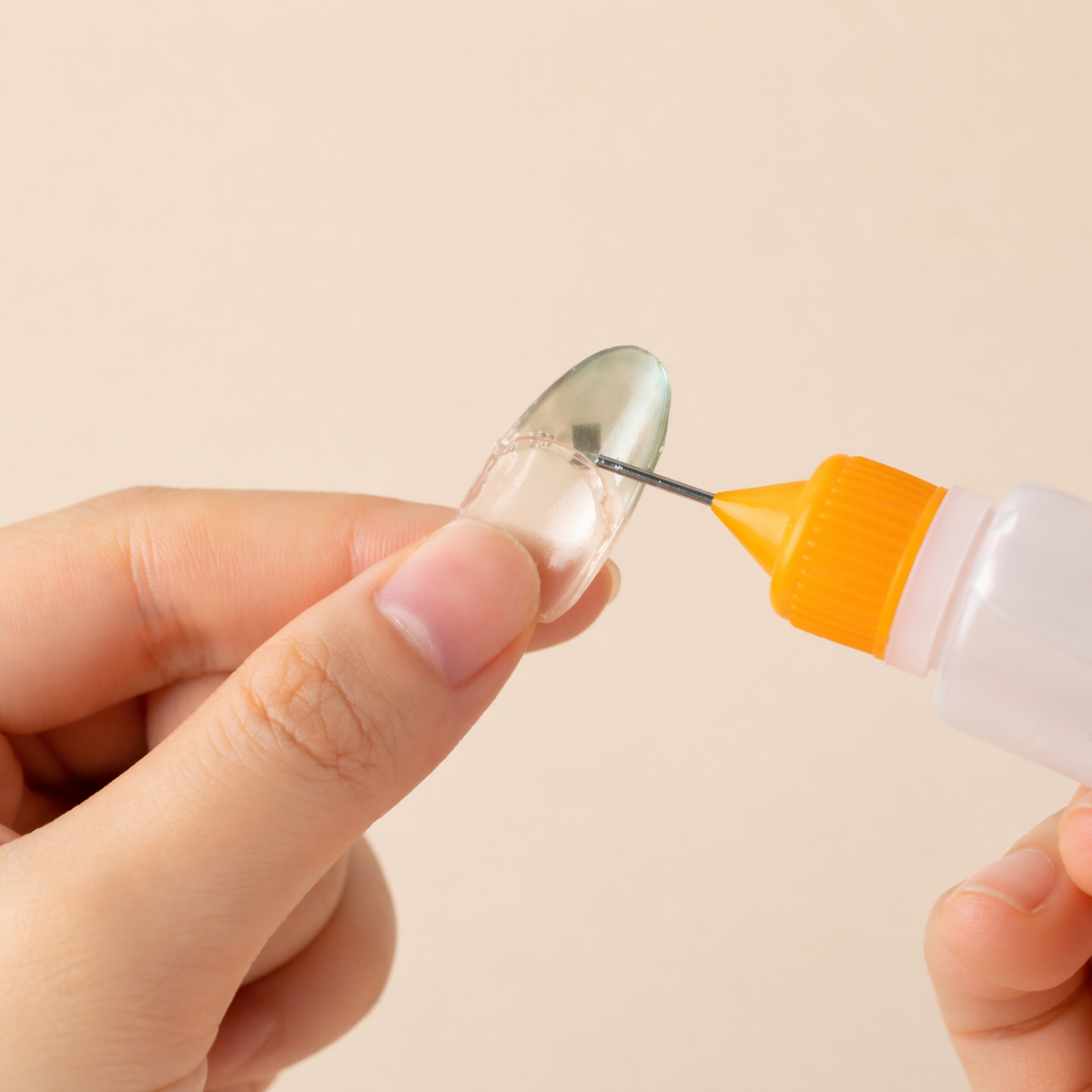 Adding remover inside a removed press-on nail to loosen adhesive