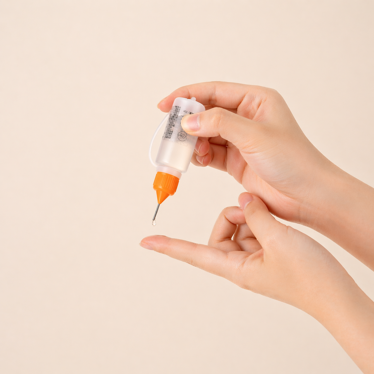 Hand holding press-on nail remover with a precision nozzle