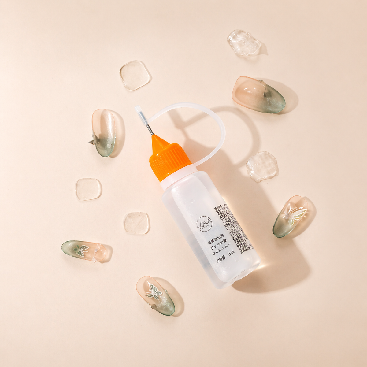 Product photo with press-on nail remover, nail tips, and adhesive