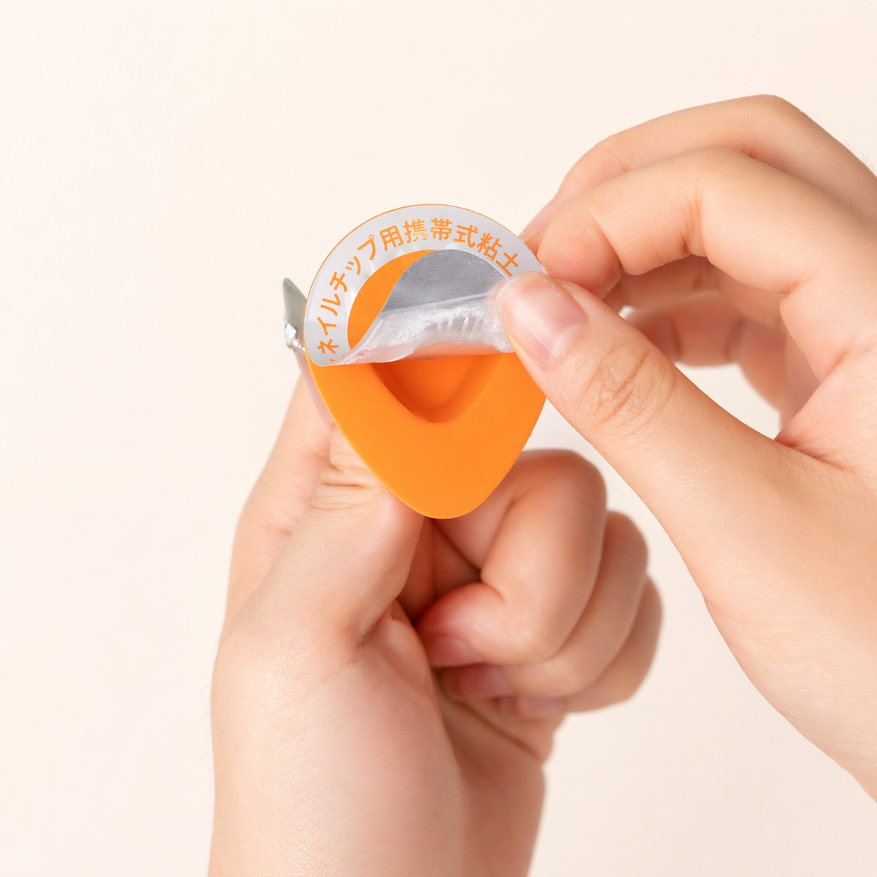 Hand peeling the protective film from portable nail adhesive gel
